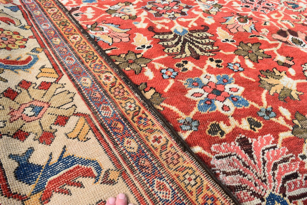 A large hand-knotted antique Persian Mahal carpet featuring a rust-red field filled with an intricate all-over floral pattern surrounded by a contrasting cream main border. View VI
