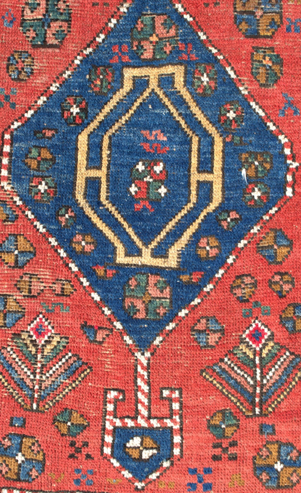 An antique hand-knotted Persian Heriz runner rug featuring five blue diamond medallions along a red field with ochre borders. View II