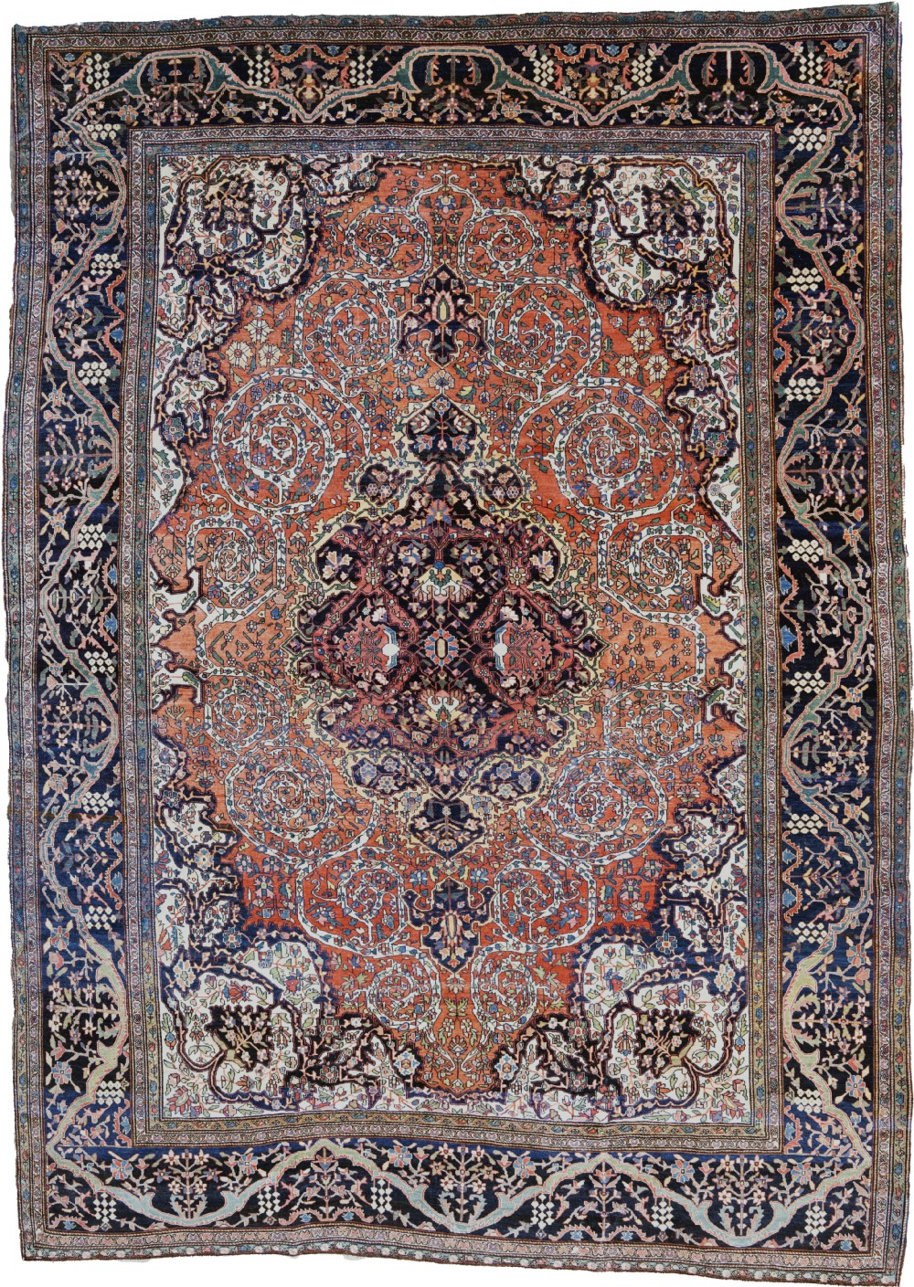 A large hand-knotted Persian Sarouk Ferahan carpet featuring a dark central medallion on a terracotta field with intricate floral arabesques and a multi-tiered navy border.