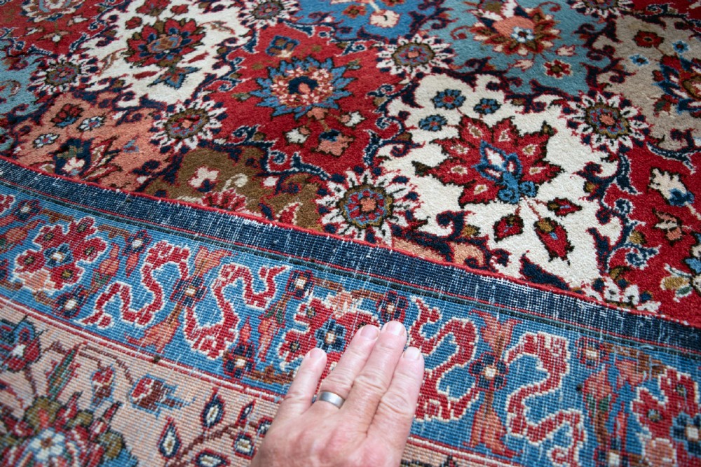A large hand-knotted antique Persian Tabriz carpet displaying an intricate diamond lattice floral pattern in red, blue, and cream tones. View IV