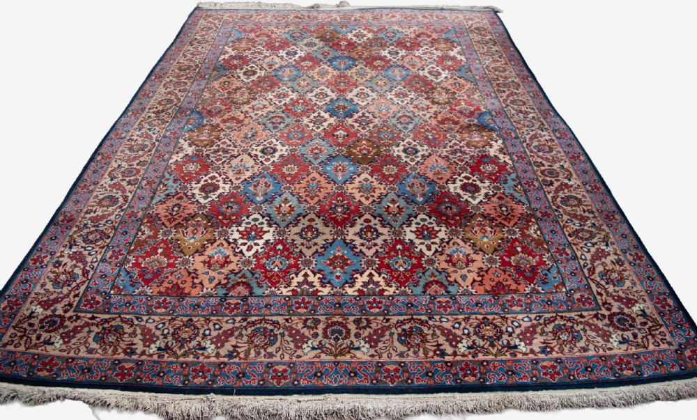 A large hand-knotted antique Persian Tabriz carpet displaying an intricate diamond lattice floral pattern in red, blue, and cream tones. View V