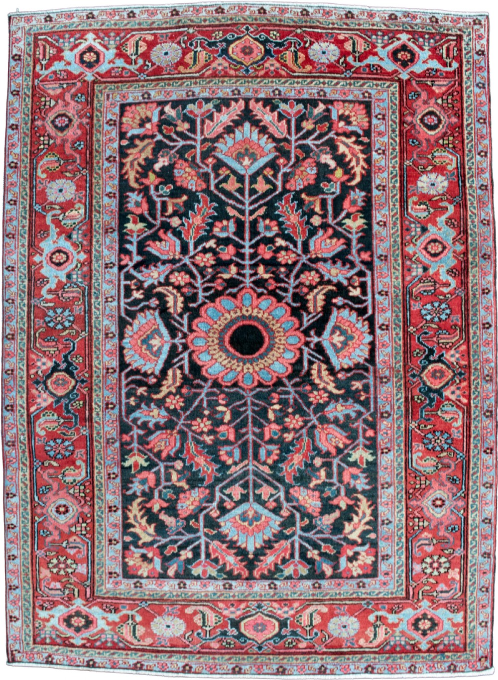 An antique hand-knotted Heriz wool rug featuring a central floral medallion surrounded by angular botanical motifs on a dark ground with a red geometric border.