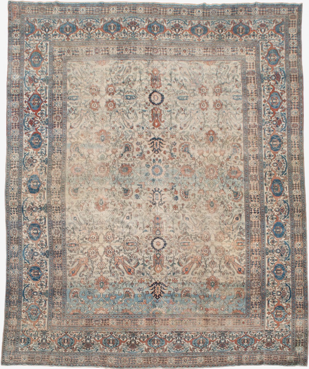 An oversize hand-knotted Khorasan carpet featuring a cream field with floral palmettes and a multi-tiered blue and terracotta border.