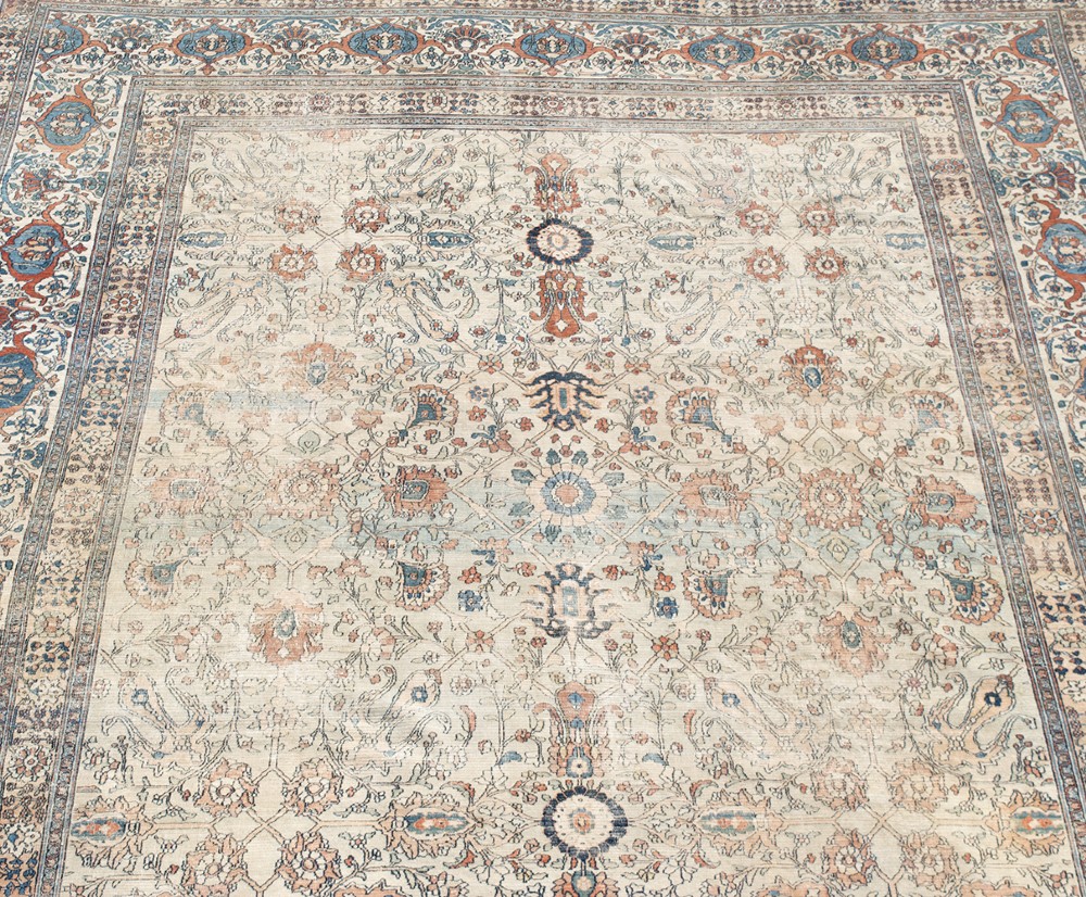 An oversize hand-knotted Khorasan carpet featuring a cream field with floral palmettes and a multi-tiered blue and terracotta border. View VIII