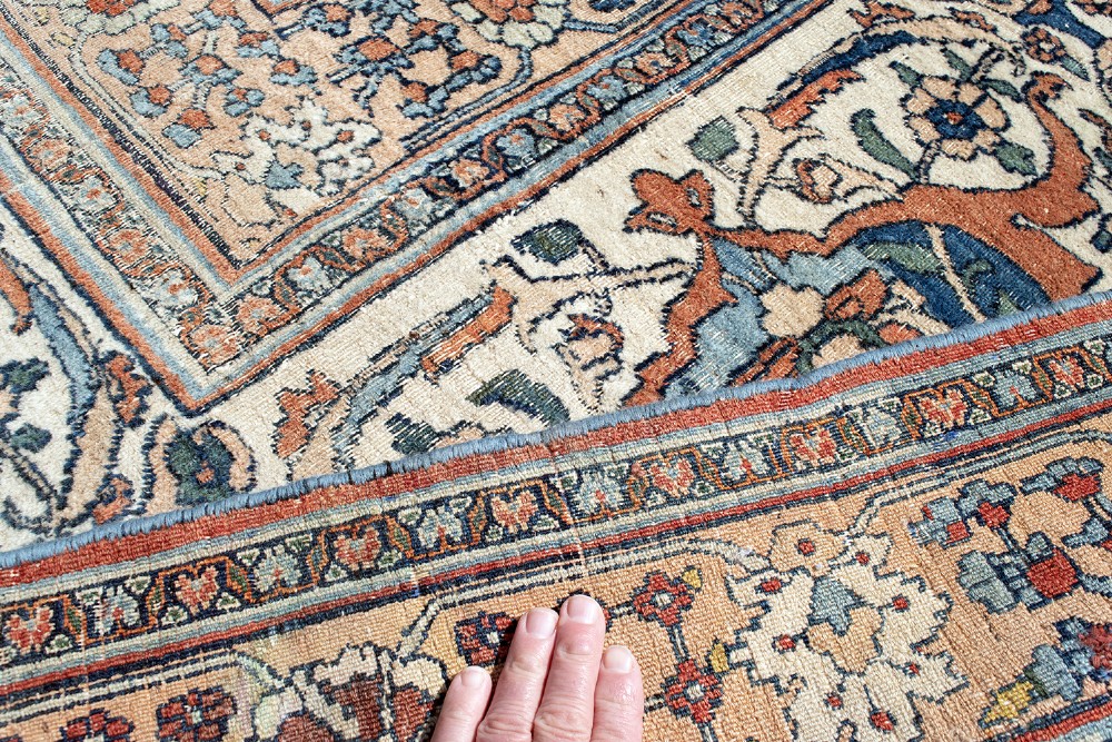 An oversize hand-knotted Khorasan carpet featuring a cream field with floral palmettes and a multi-tiered blue and terracotta border. View IX