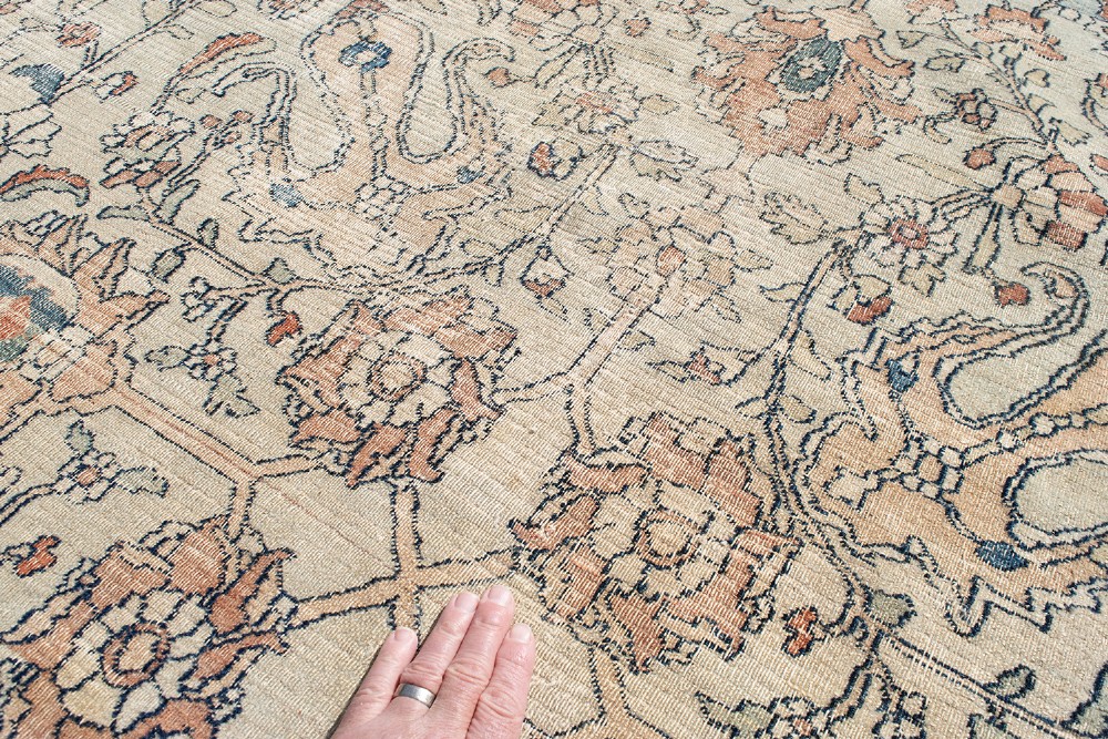 An oversize hand-knotted Khorasan carpet featuring a cream field with floral palmettes and a multi-tiered blue and terracotta border. View X