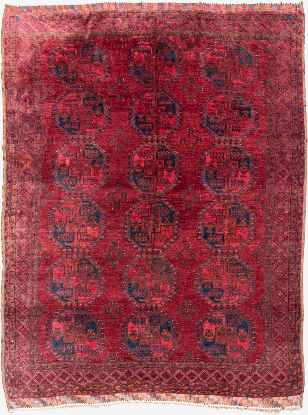 A large hand-knotted wool Afghan carpet featuring repeating octagonal gul motifs on a rich deep red field with geometric borders.