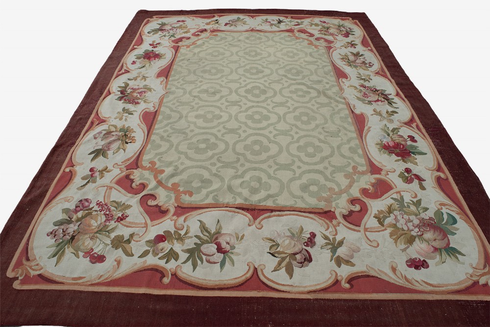 An antique French Aubusson flat-weave carpet featuring a central sage green geometric field framed by a rich floral cartouche border and a solid burgundy outer rim. View II