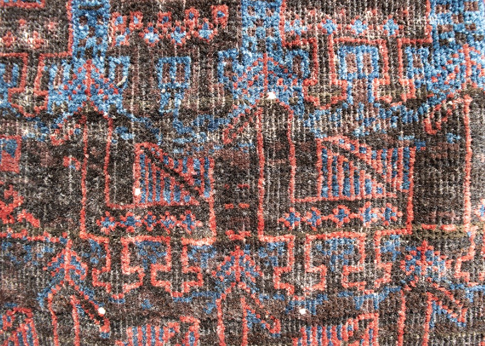 An antique square handwoven Baluch wool bag face featuring rows of stylised terracotta and blue bird motifs on a dark brown ground framed by a white geometric border. View II