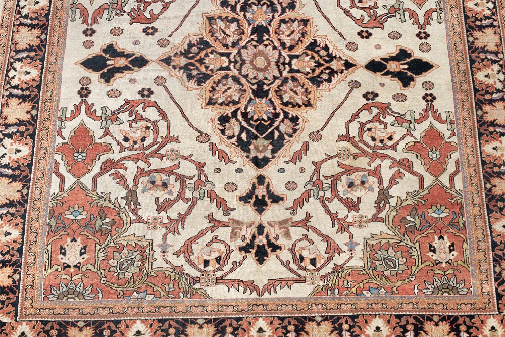 A large hand-knotted antique Mahal Persian carpet featuring a central dark blue floral medallion on an ivory field framed by terracotta spandrels and a multi-tiered border. View III
