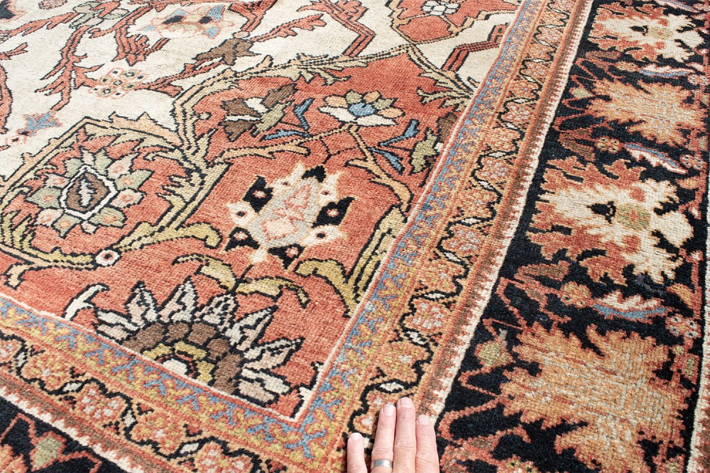 A large hand-knotted antique Mahal Persian carpet featuring a central dark blue floral medallion on an ivory field framed by terracotta spandrels and a multi-tiered border. View IX