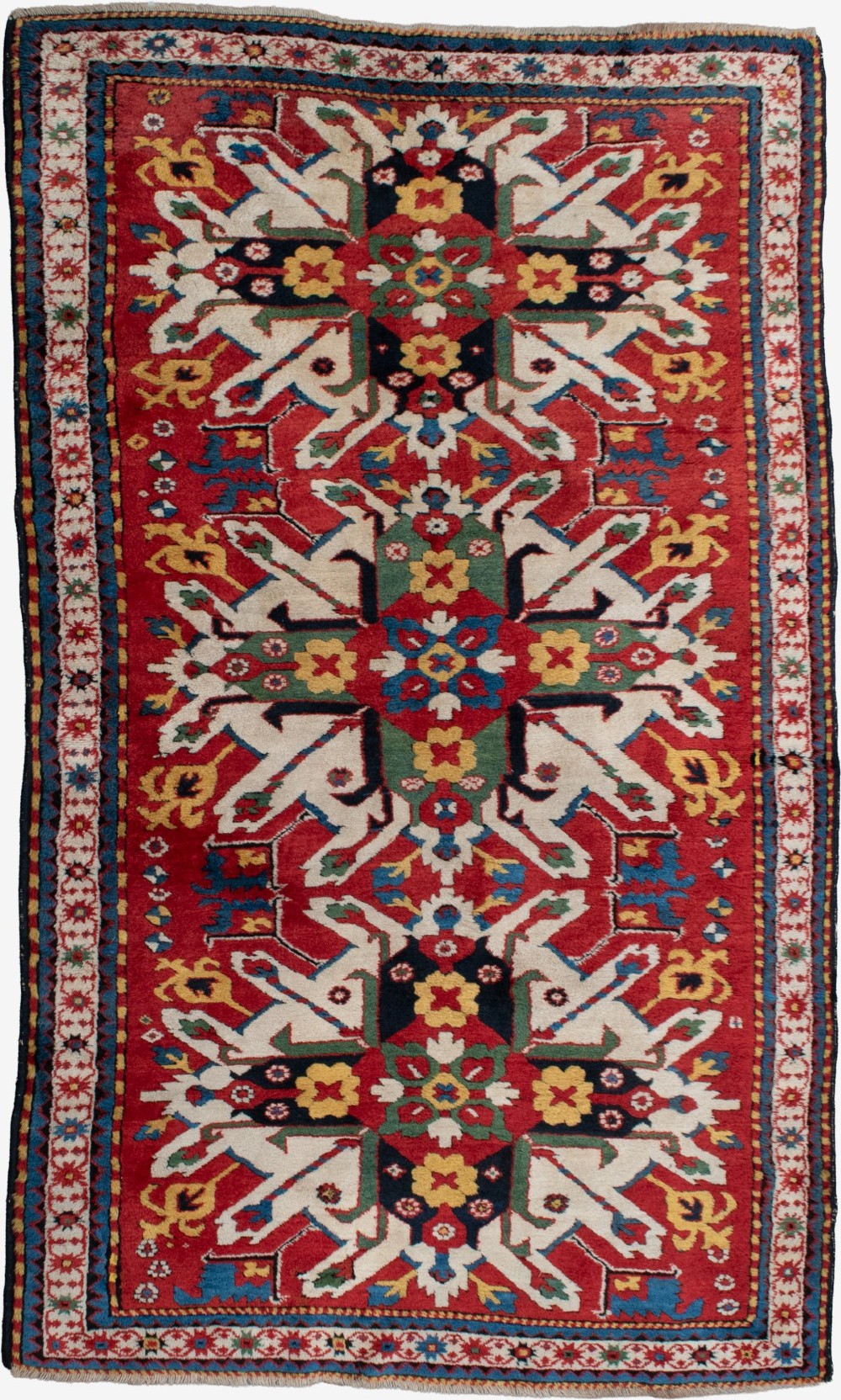 An antique hand-knotted Caucasian Eagle Kazak wool rug featuring repeating ivory geometric eagle medallions on a vibrant red field with a patterned border.