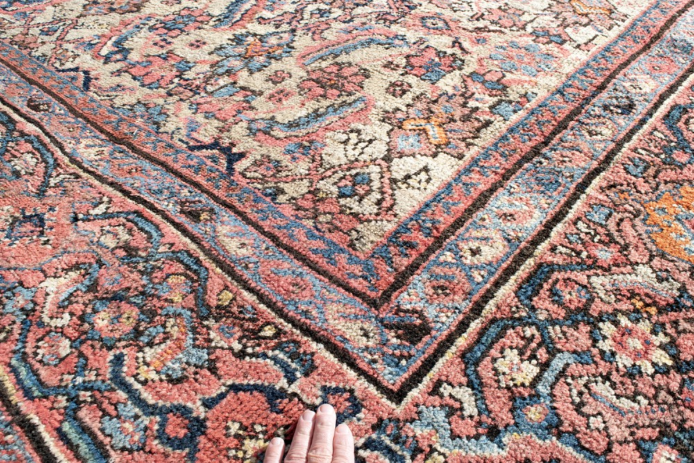 An antique Persian Ferahan wool carpet featuring a dense floral pattern on a cream field surrounded by a terracotta multi-banded border. View V