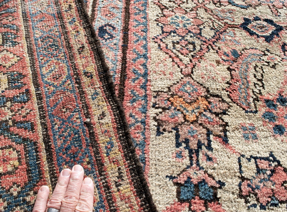 An antique Persian Ferahan wool carpet featuring a dense floral pattern on a cream field surrounded by a terracotta multi-banded border. View VII