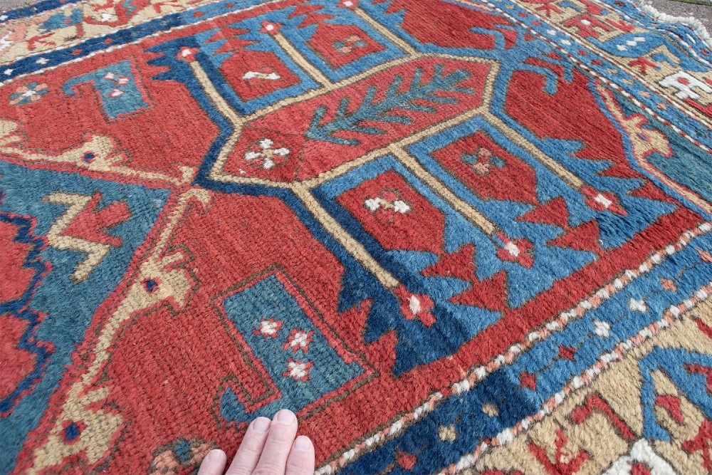 A long hand-knotted antique Heriz runner rug with geometric medallions in red, blue, turquoise, and cream tones. View IV