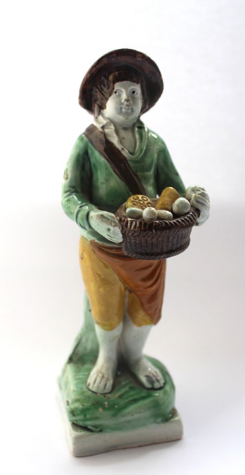 Staffordshire Pearlware Figure of a Boy with a Basket, Circa 1800
