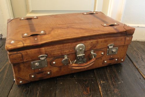 A Large Vintage Tan Leather Suitcase with Chrome Studs