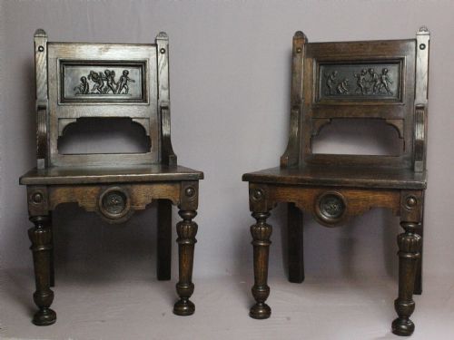 Unusual Pair of Oak Hall Chairs Inset with Terracotta Plaques