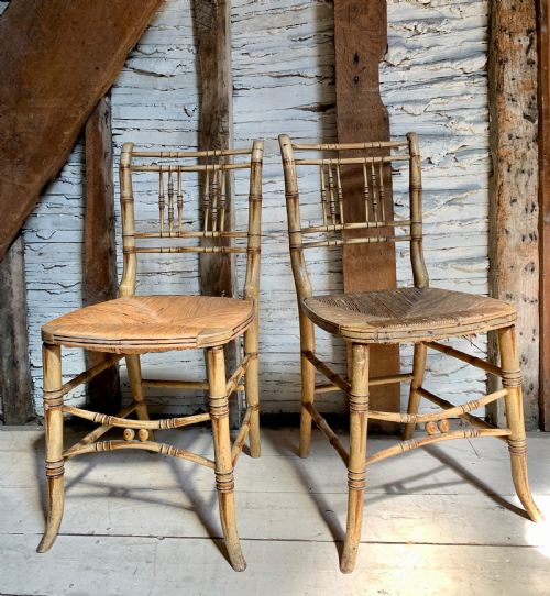 Pair of Regency Painted Faux Bamboo Chairs with Rush Seats