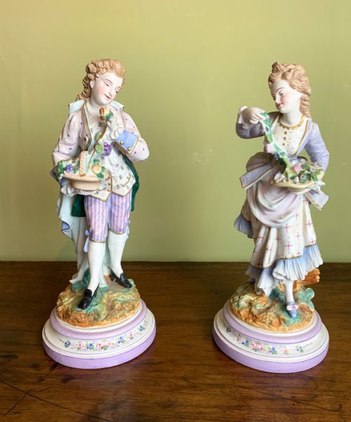 Pair of French Bisque Porcelain Figures with Baskets of Flowers