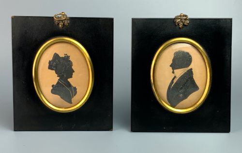 Pair of Regency Cut Paper Silhouettes of a Lady and Gentleman with Painted Highlights