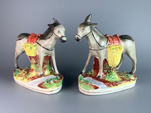 Pair of Victorian Staffordshire Pottery Donkeys Carrying Paneers
