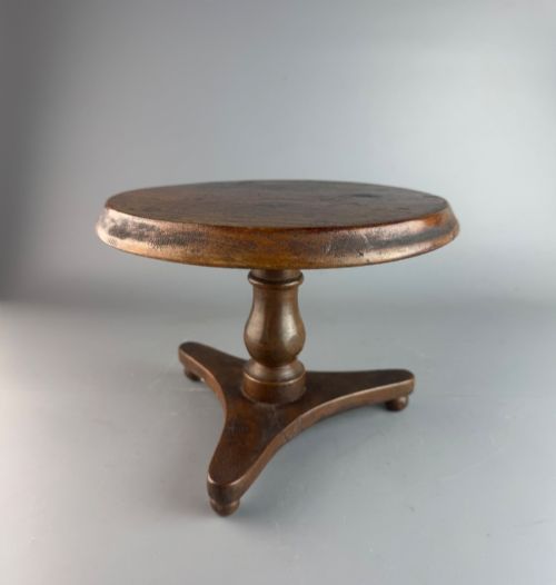 A VICTORIAN TREEN CANDLESTAND IN THE FORM OF A TIPTOP TRIPOD TABLE