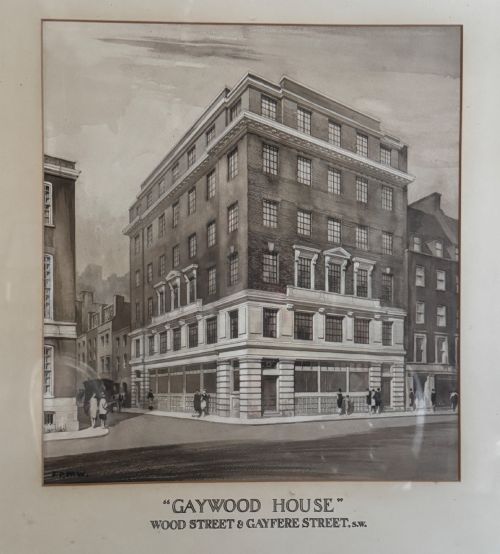 fig 1. A framed 1920s monochrome architectural watercolour drawing of Gaywood House in Westminster, depicted from a street corner perspective within a black frame.
