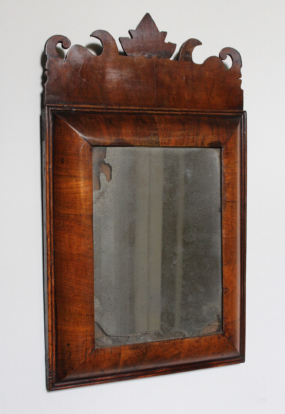 A George I Mahogany Cushion Framed Wall Mirror of small proportions, circa 1720