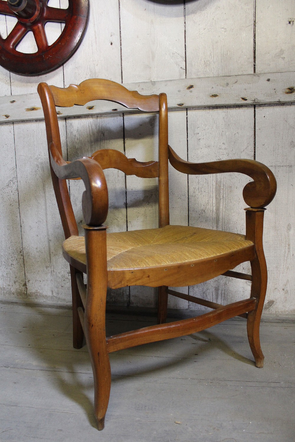 French fruitwood fauteuil / open armchair with rush seat.