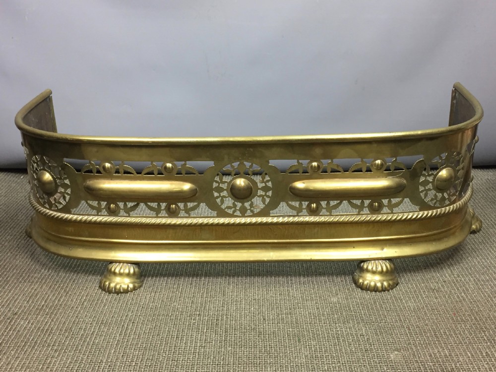 Small Pierced Brass Fireside Fender with lions paw feet