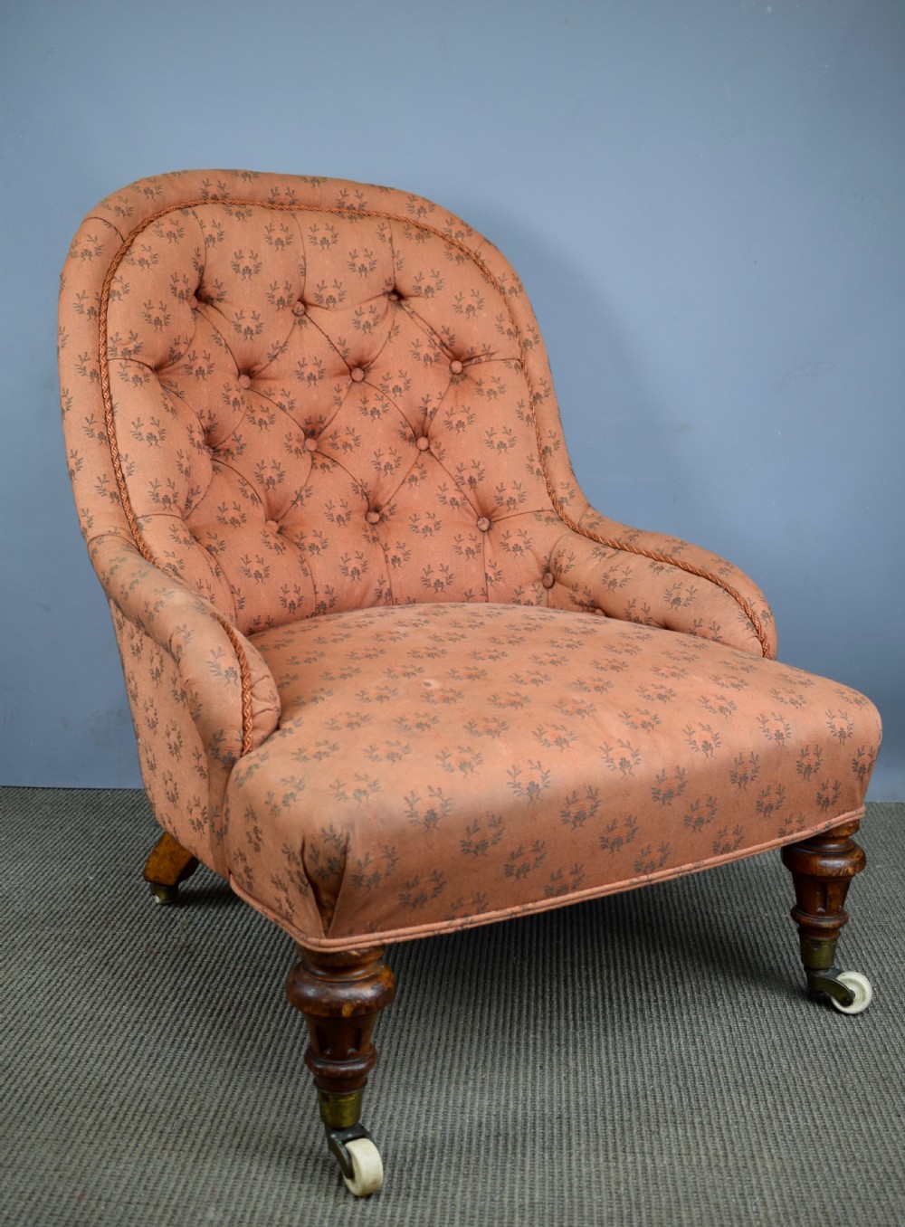 Antique button back armchair of small proportions with Cope & Collinson castors