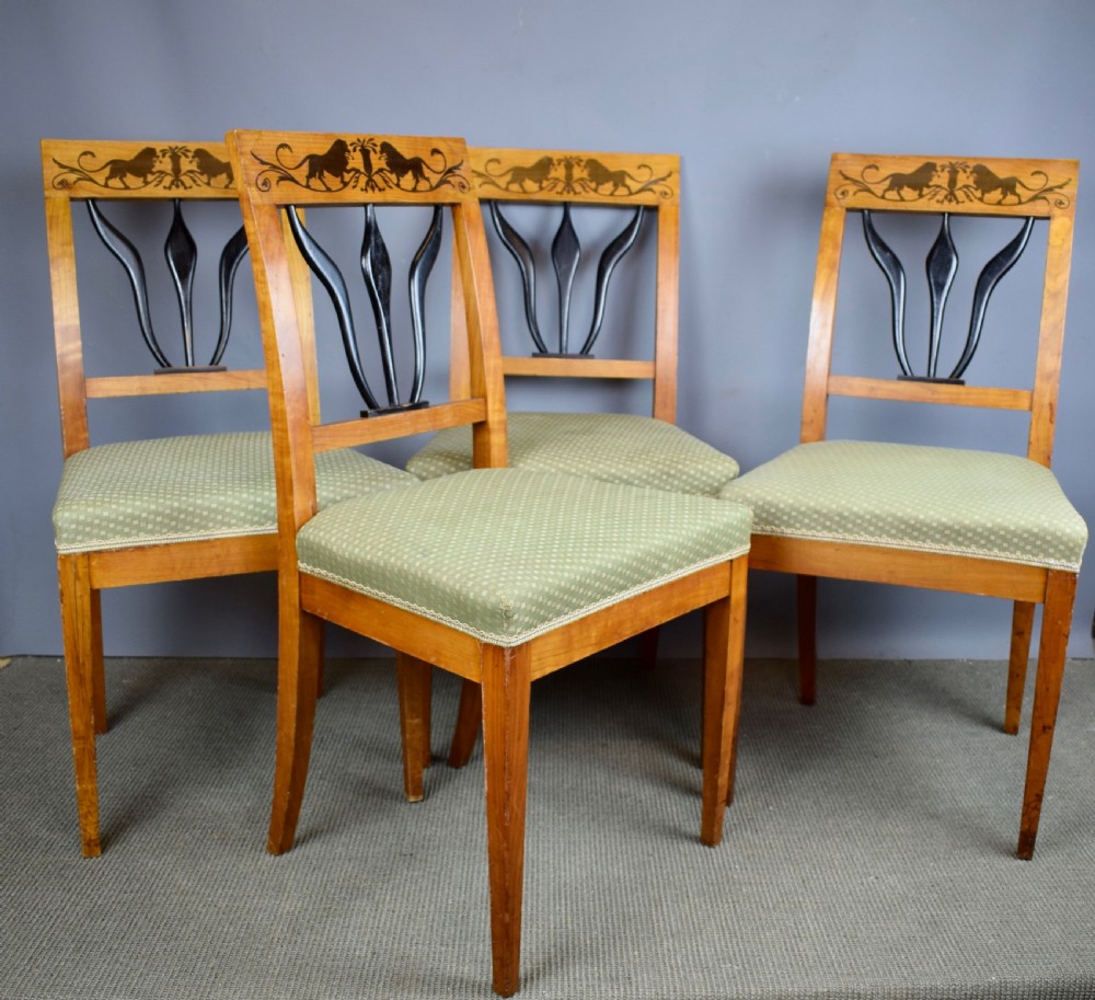 Set of four Biedermeier inlaid satinwood dining chairs with lion decoration View II
