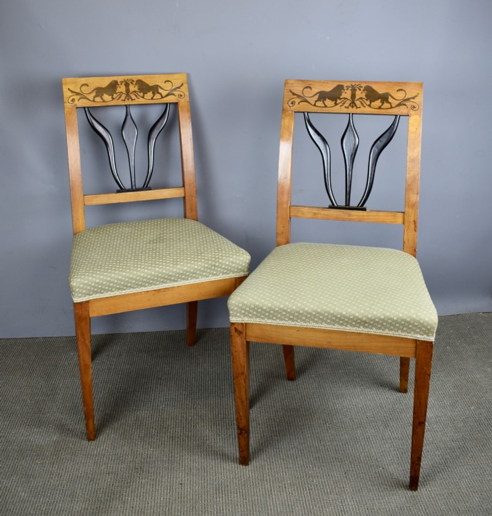 Set of four Biedermeier inlaid satinwood dining chairs with lion decoration View III