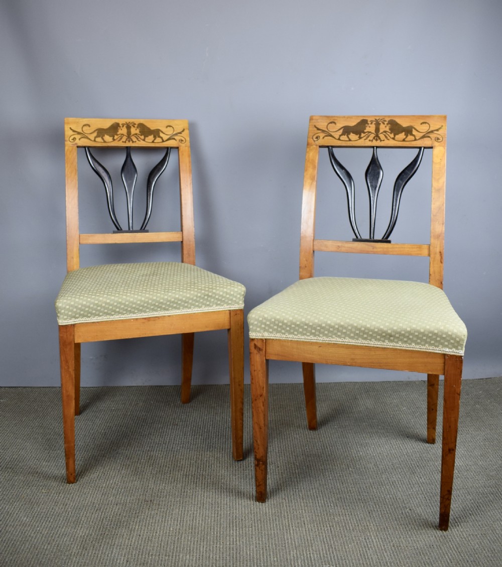 Set of four Biedermeier inlaid satinwood dining chairs with lion decoration View IV