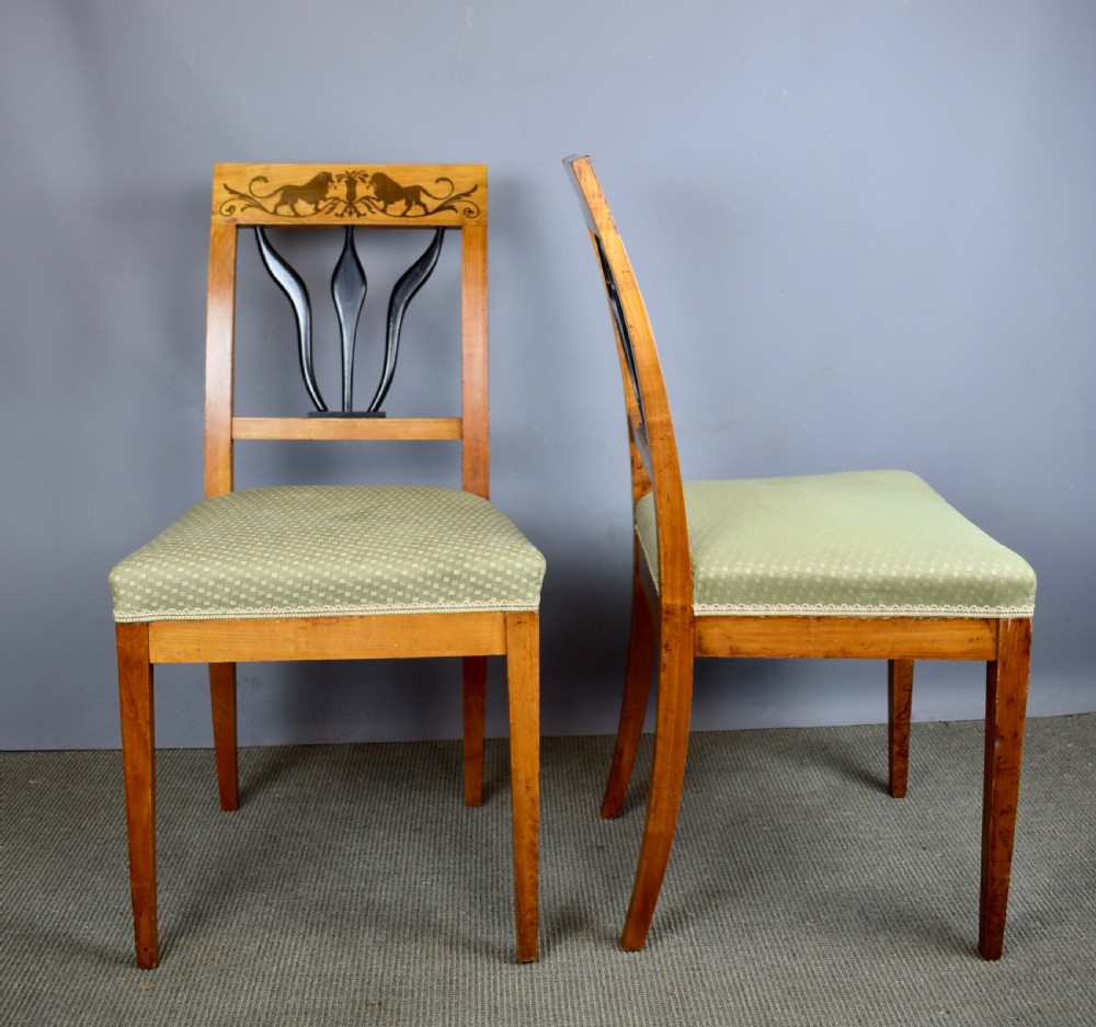 Set of four Biedermeier inlaid satinwood dining chairs with lion decoration View V