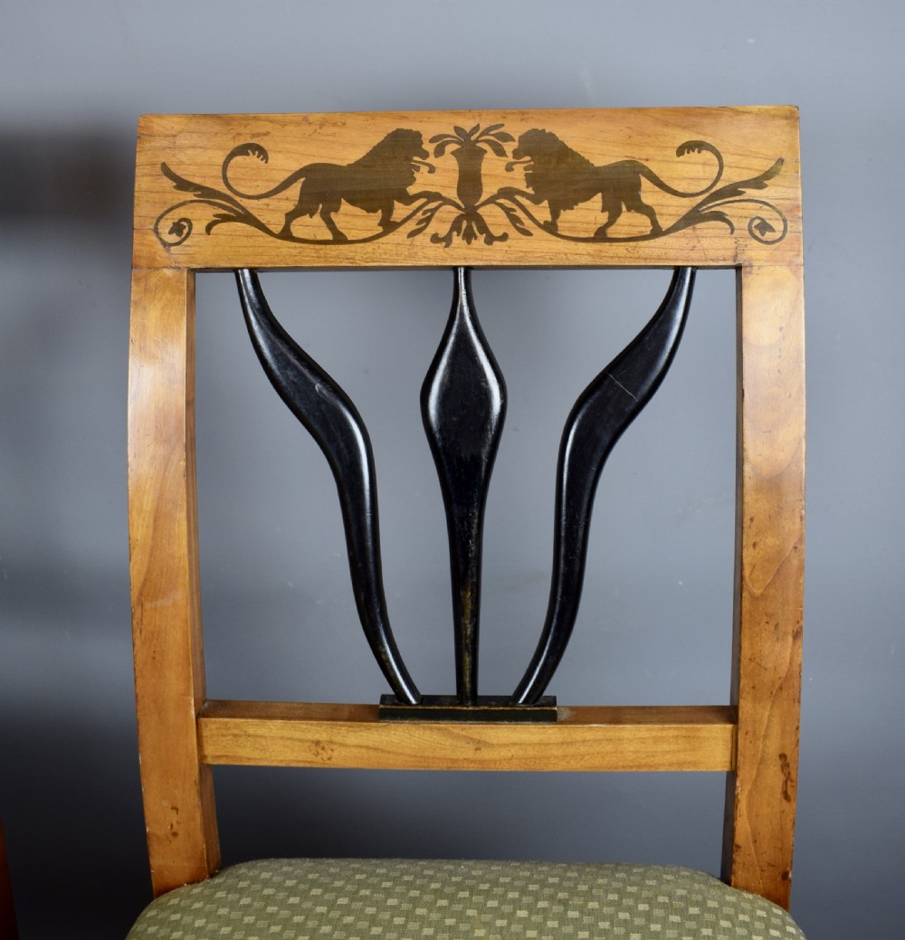Set of four Biedermeier inlaid satinwood dining chairs with lion decoration View VI