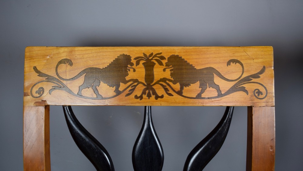 Set of four Biedermeier inlaid satinwood dining chairs with lion decoration View VII
