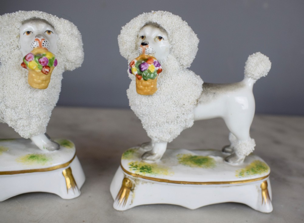 Pair of French Samson porcelain poodles carrying baskets in their mouths View II
