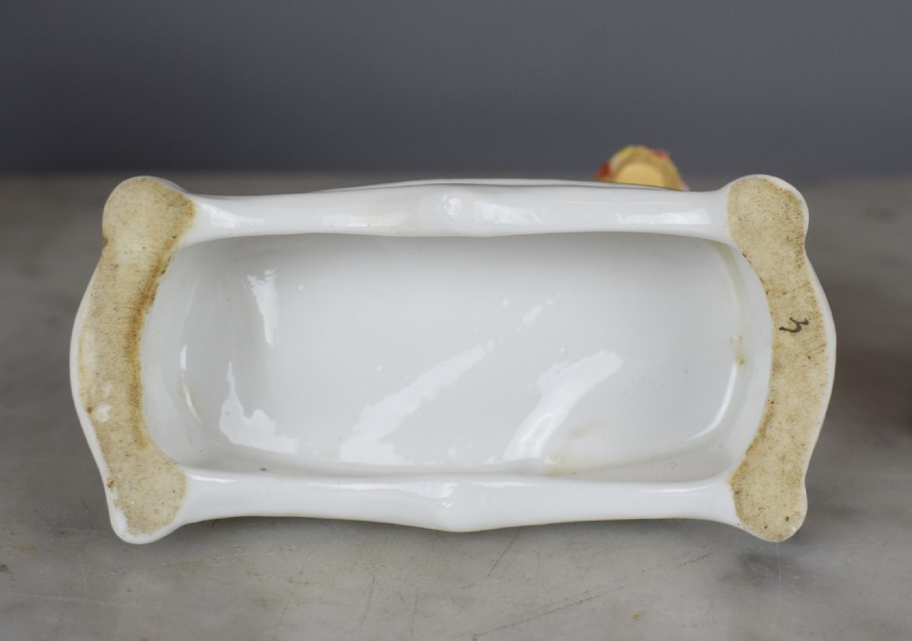 Pair of French Samson porcelain poodles carrying baskets in their mouths View V