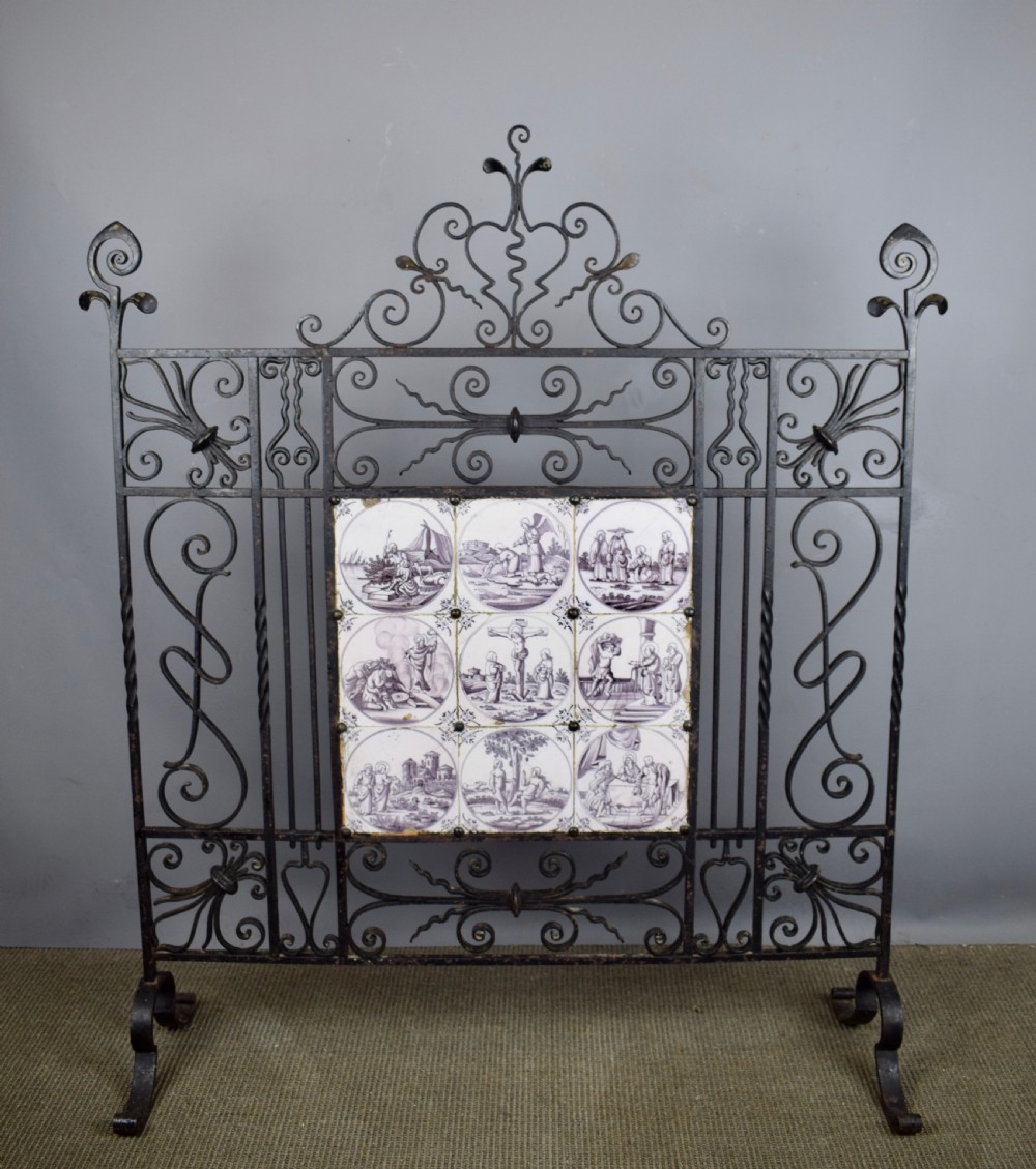 Wrought iron fire screen inset with 18th century manganese Delft tiles View II