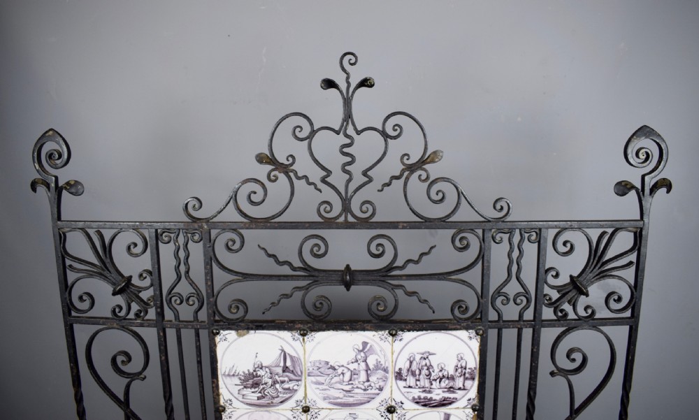 Wrought iron fire screen inset with 18th century manganese Delft tiles View III