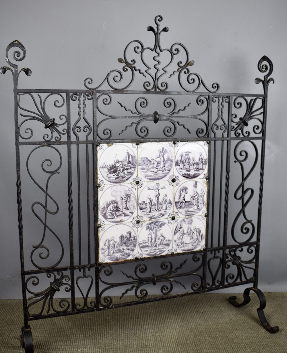 Wrought iron fire screen inset with 18th century manganese Delft tiles View VII