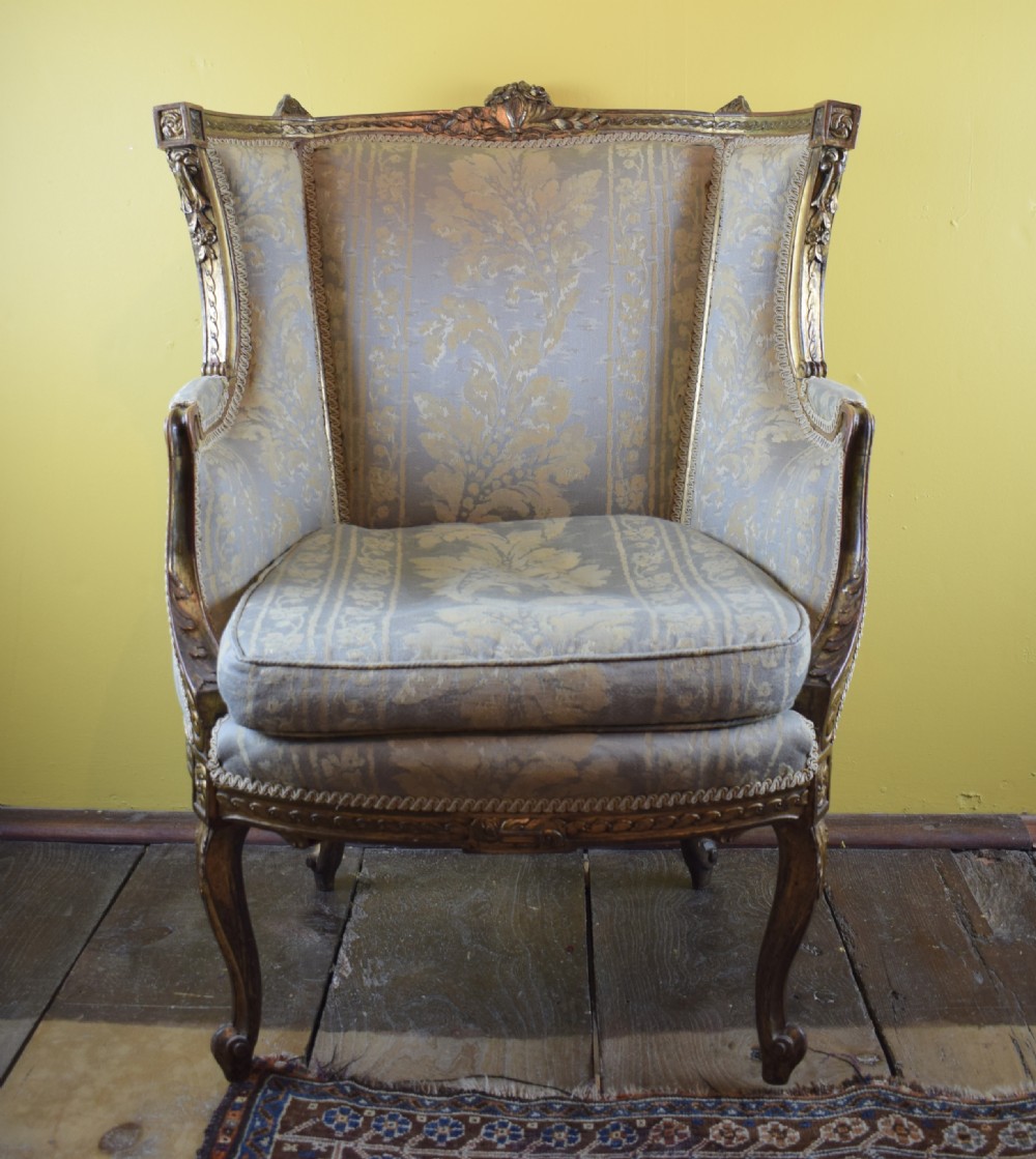 Antique French gilt wood wingback armchair in Louis XVI style View II