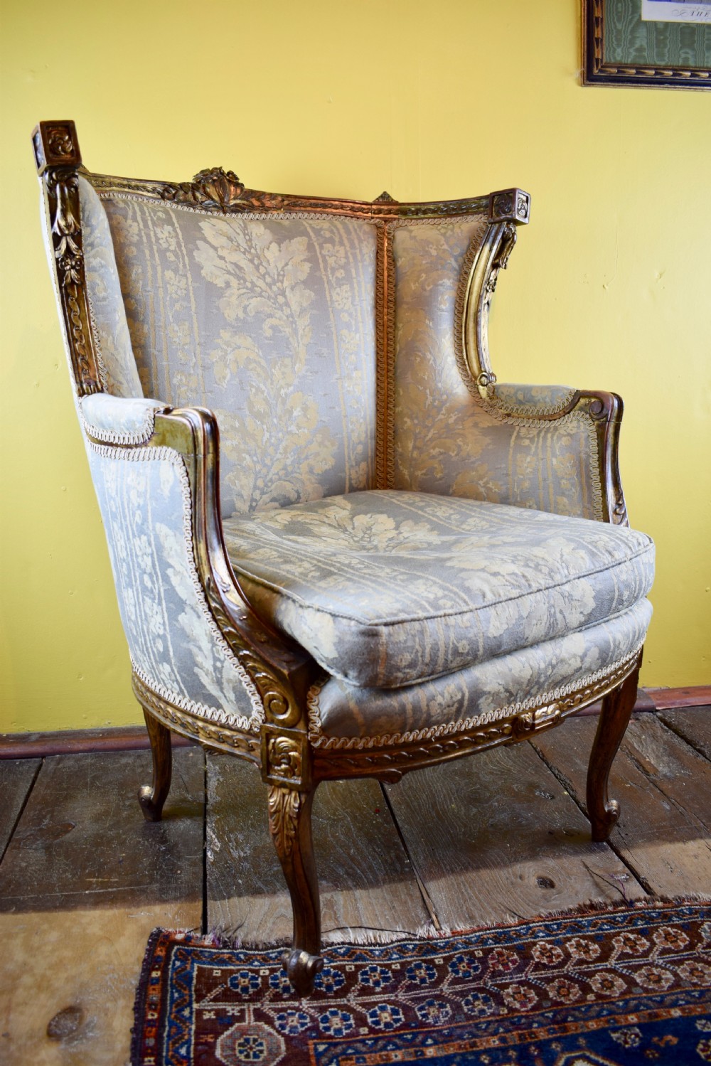 Antique French gilt wood wingback armchair in Louis XVI style View IV