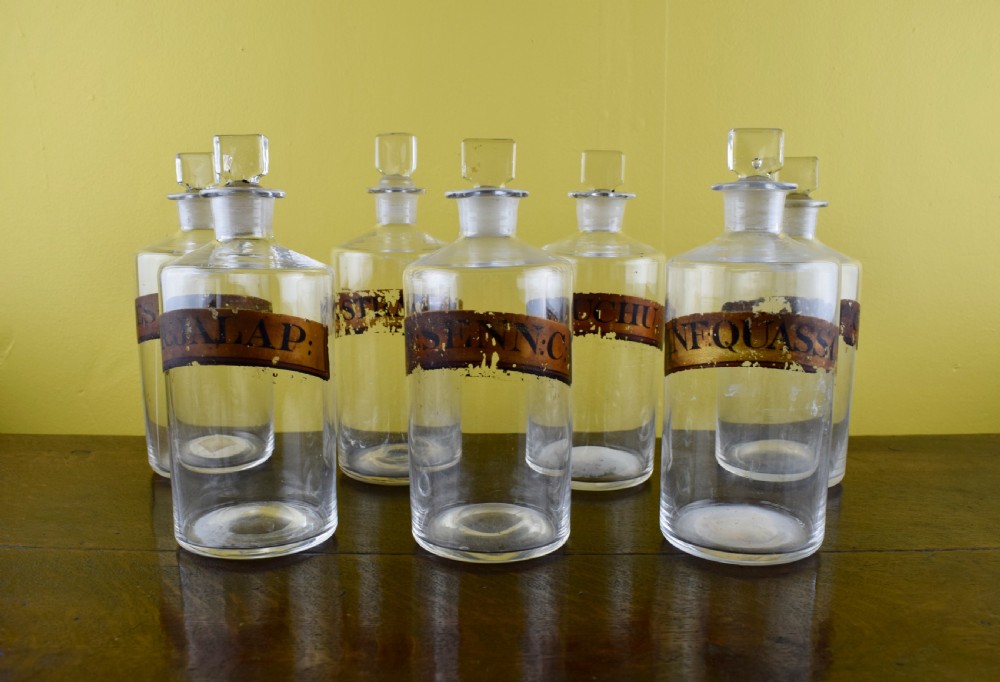 Seven Antique blown glass pharmacy bottles with gilt labels View III