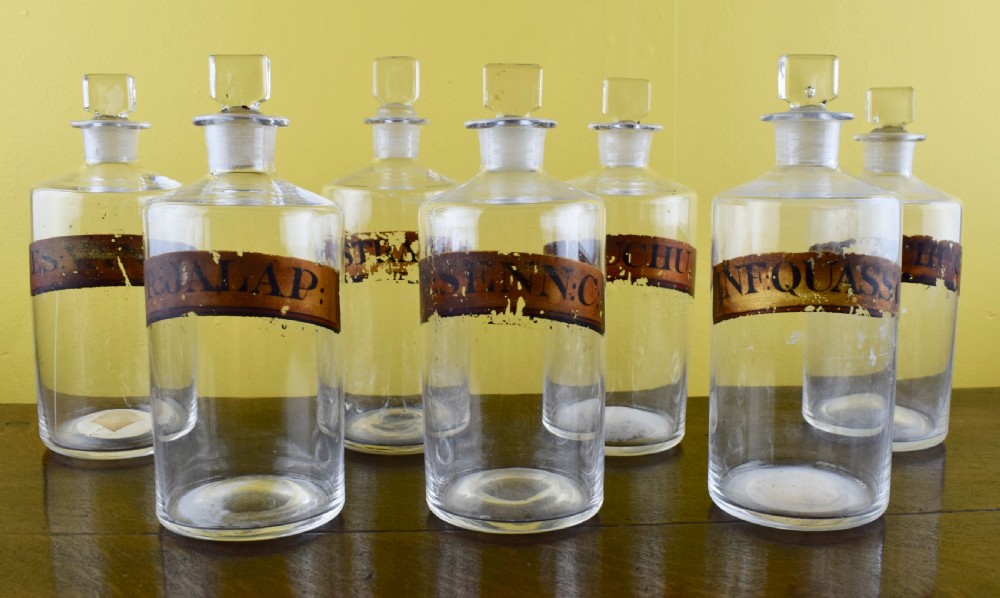 Seven Antique blown glass pharmacy bottles with gilt labels View IV