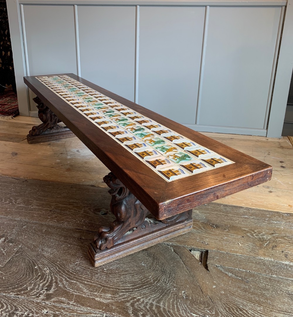 Unusual tile top bench with carved oak griffin supports View II