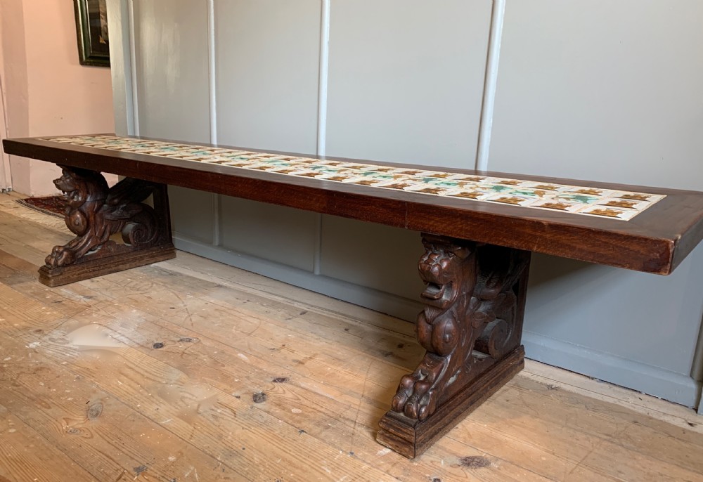 Unusual tile top bench with carved oak griffin supports View III