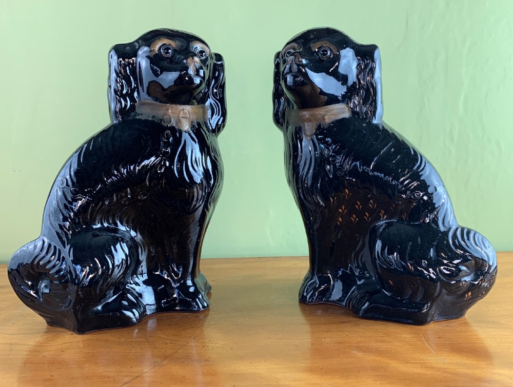 Pair of Victorian black Staffordshire dogs with glass eyes